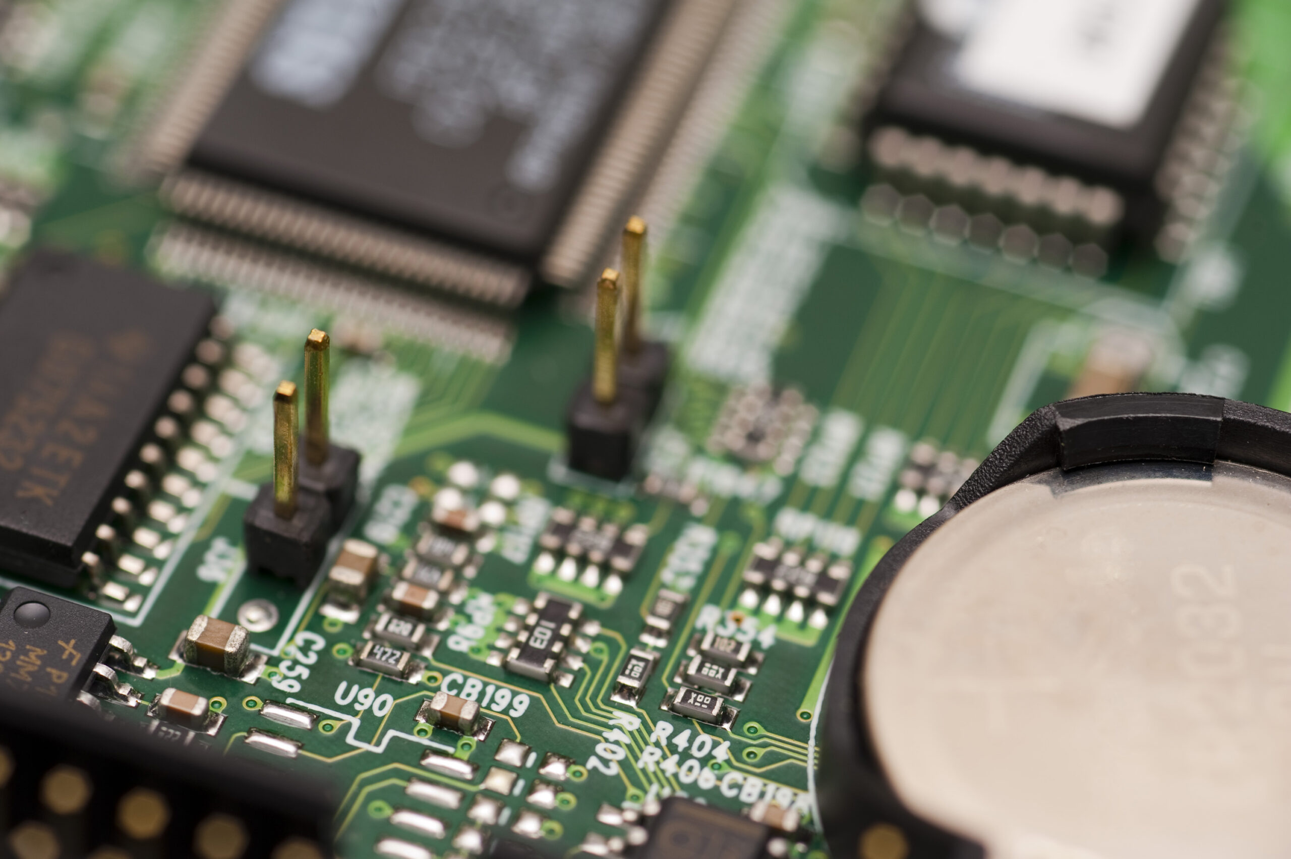 a narrow depth of field image details an electronic circuit board, pictured with a narrrow depth of field