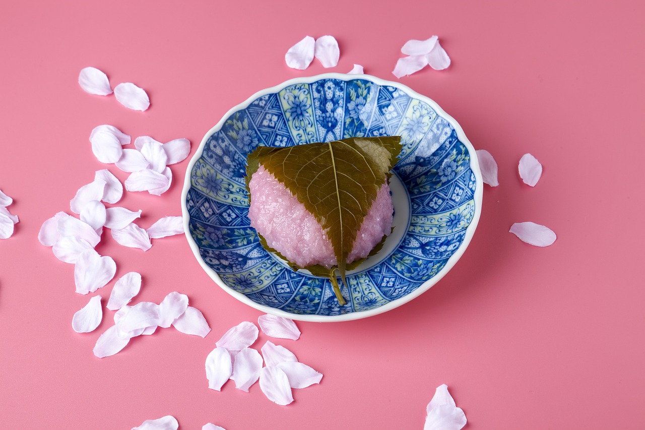 a traditional pink rice cake filled with sweet red bean paste and wrapped in a salted cherry leaf.