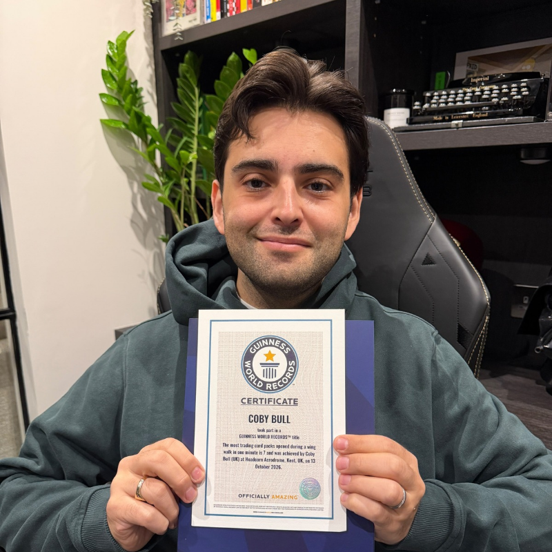 Daredevil collector sets bizarre Guinness World Record by ripping open trading cards while strapped to wing of flying plane