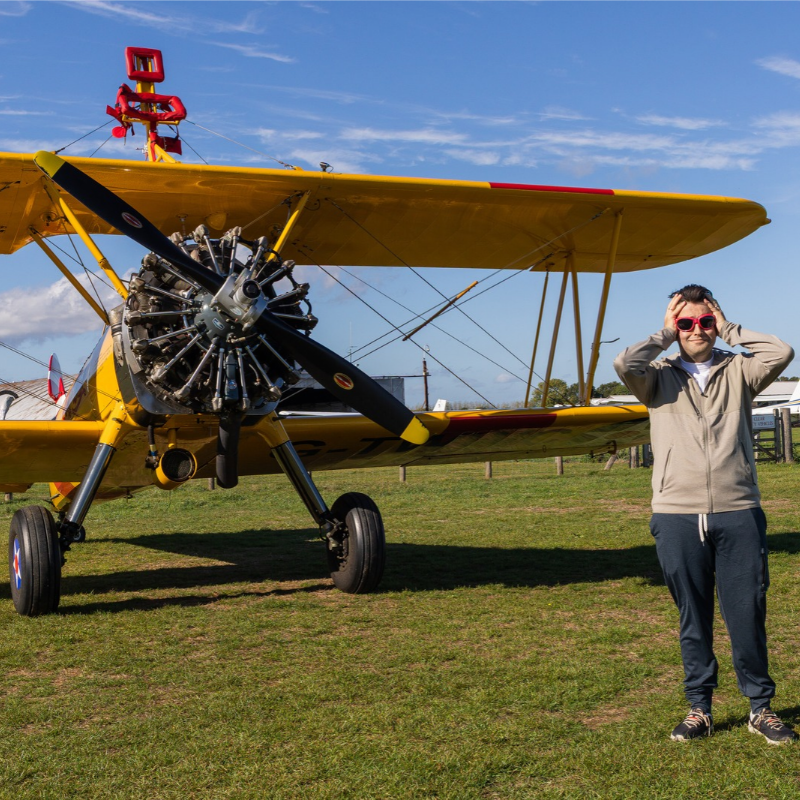 Daredevil collector sets bizarre Guinness World Record by ripping open trading cards while strapped to wing of flying plane